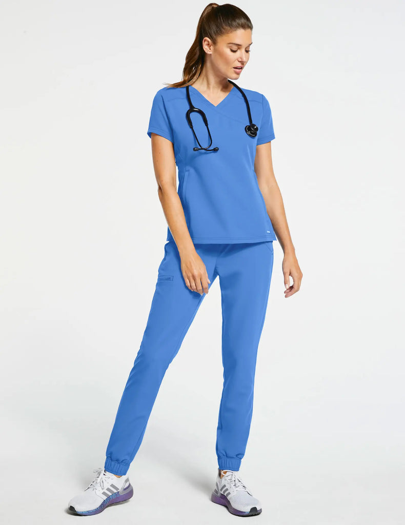 Jaanuu Scrubs Women's 3-Pocket Mock Wrap Top Ceil Blue | scrub-supply.com