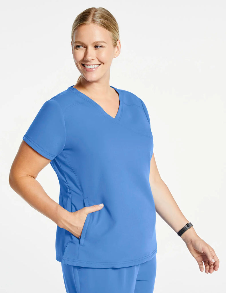 Jaanuu Scrubs Women's 3-Pocket Mock Wrap Top Ceil Blue | scrub-supply.com