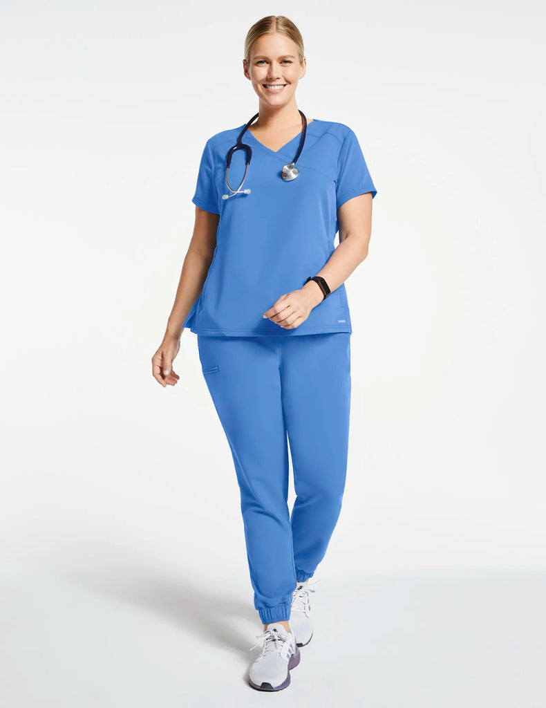 Jaanuu Scrubs Women's 3-Pocket Mock Wrap Top Ceil Blue | scrub-supply.com