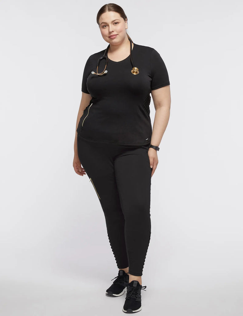 Jaanuu Scrubs Women's Women’s Gold Zip Moto Top Black | scrub-supply.com