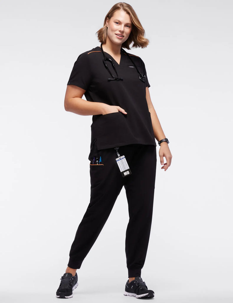 Jaanuu Scrubs Women's Stripe 3-Pocket Scrub Top Black | scrub-supply.com