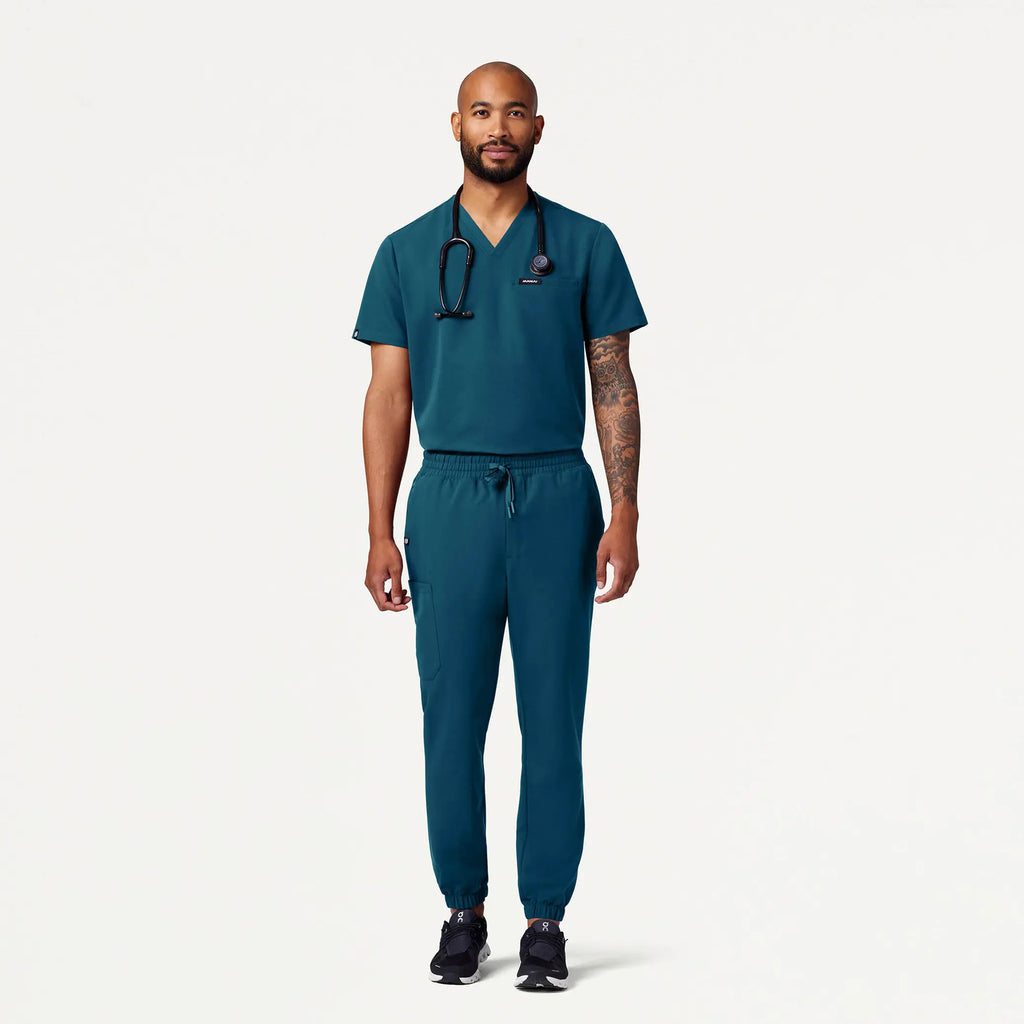 Jaanuu Scrubs Men's Romin 1-Pocket Scrub Top Caribbean Blue | scrub-supply.com