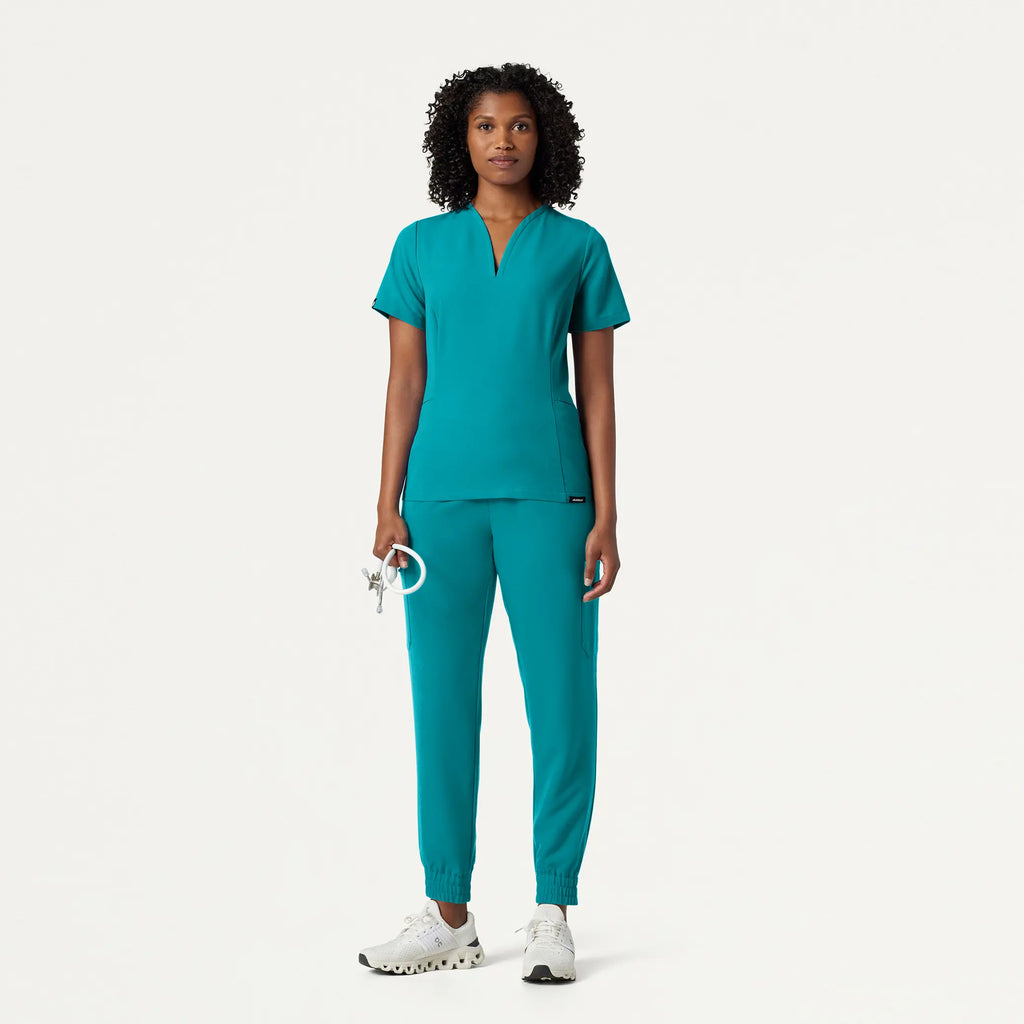 Jaanuu Scrubs Women's Calix Fit & Flare Scrub Top Aqua | scrub-supply.com