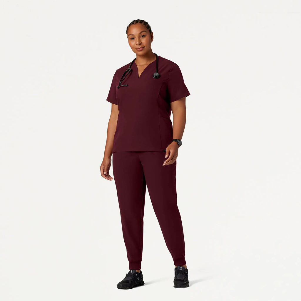 Jaanuu Scrubs Women's Calix Fit & Flare Scrub Top Burgundy | scrub-supply.com