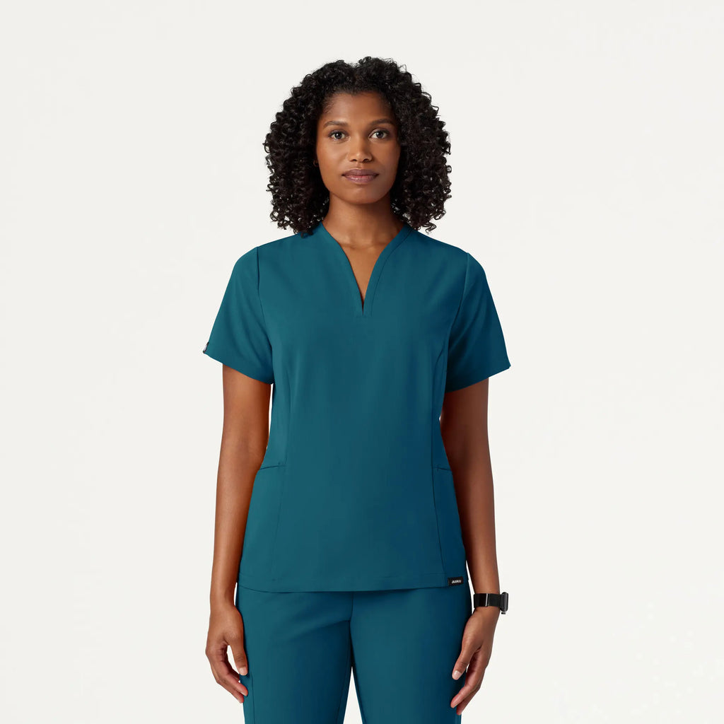 Jaanuu Scrubs Women's Calix Fit & Flare Scrub Top Caribbean Blue | scrub-supply.com