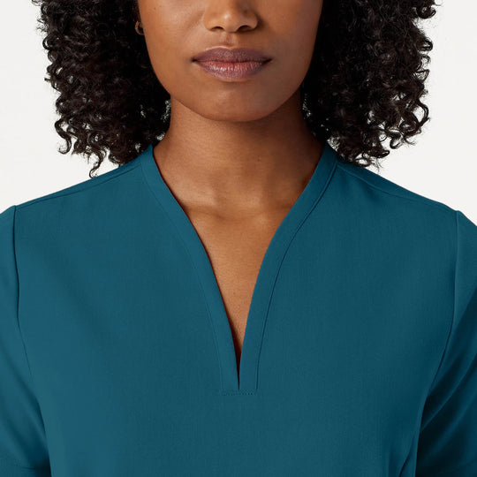 Jaanuu Scrubs Women's Calix Fit & Flare Scrub Top Caribbean Blue | scrub-supply.com