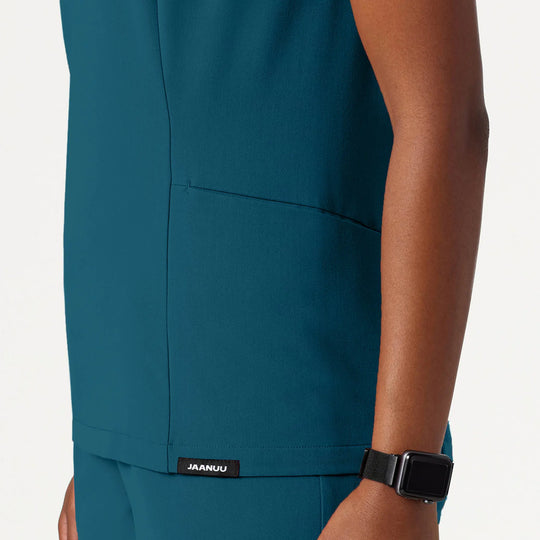 Jaanuu Scrubs Women's Calix Fit & Flare Scrub Top Caribbean Blue | scrub-supply.com