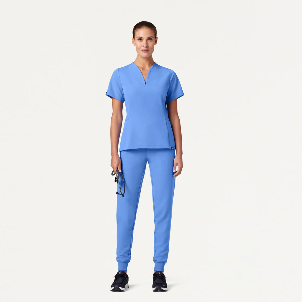 Jaanuu Scrubs Women's Calix Fit & Flare Scrub Top Ceil Blue | scrub-supply.com