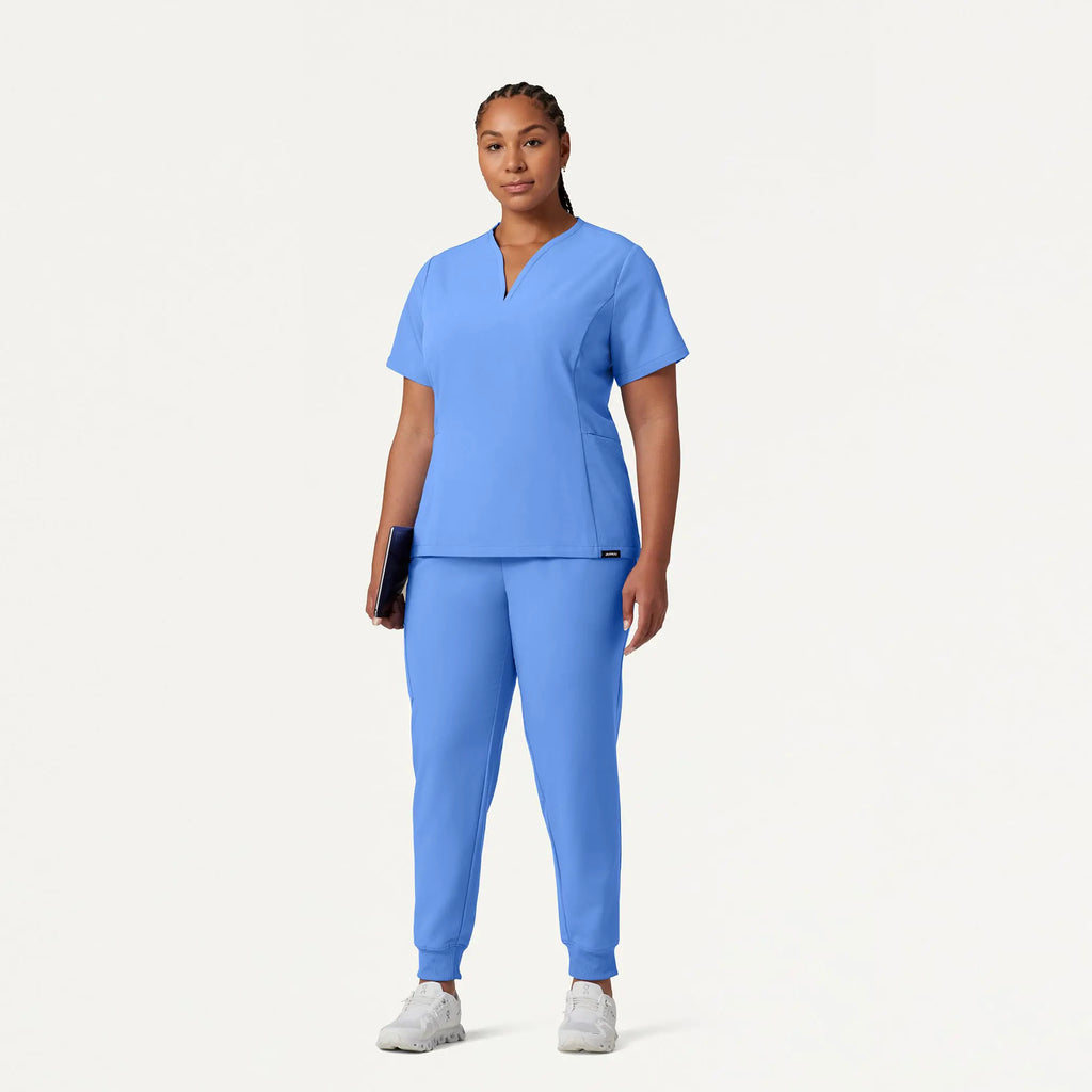 Jaanuu Scrubs Women's Calix Fit & Flare Scrub Top Ceil Blue | scrub-supply.com