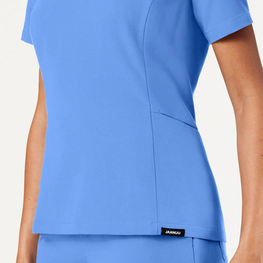 Jaanuu Scrubs Women's Calix Fit & Flare Scrub Top Ceil Blue | scrub-supply.com