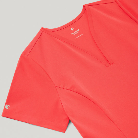 Jaanuu Scrubs Women's Calix Fit & Flare Scrub Top Coral | scrub-supply.com