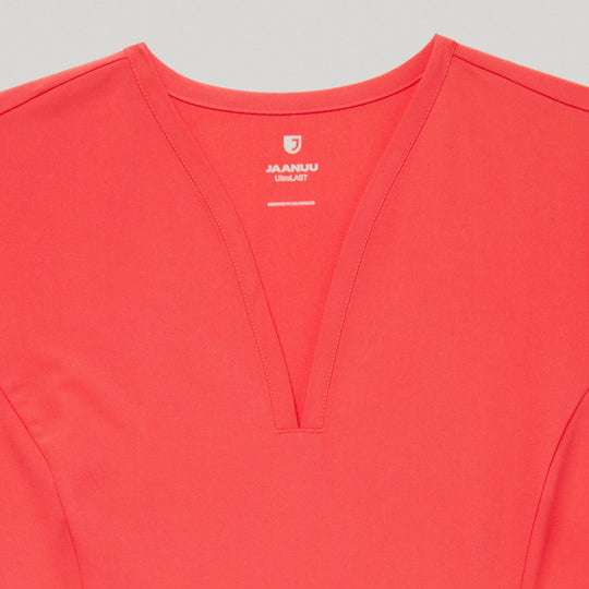 Jaanuu Scrubs Women's Calix Fit & Flare Scrub Top Coral | scrub-supply.com