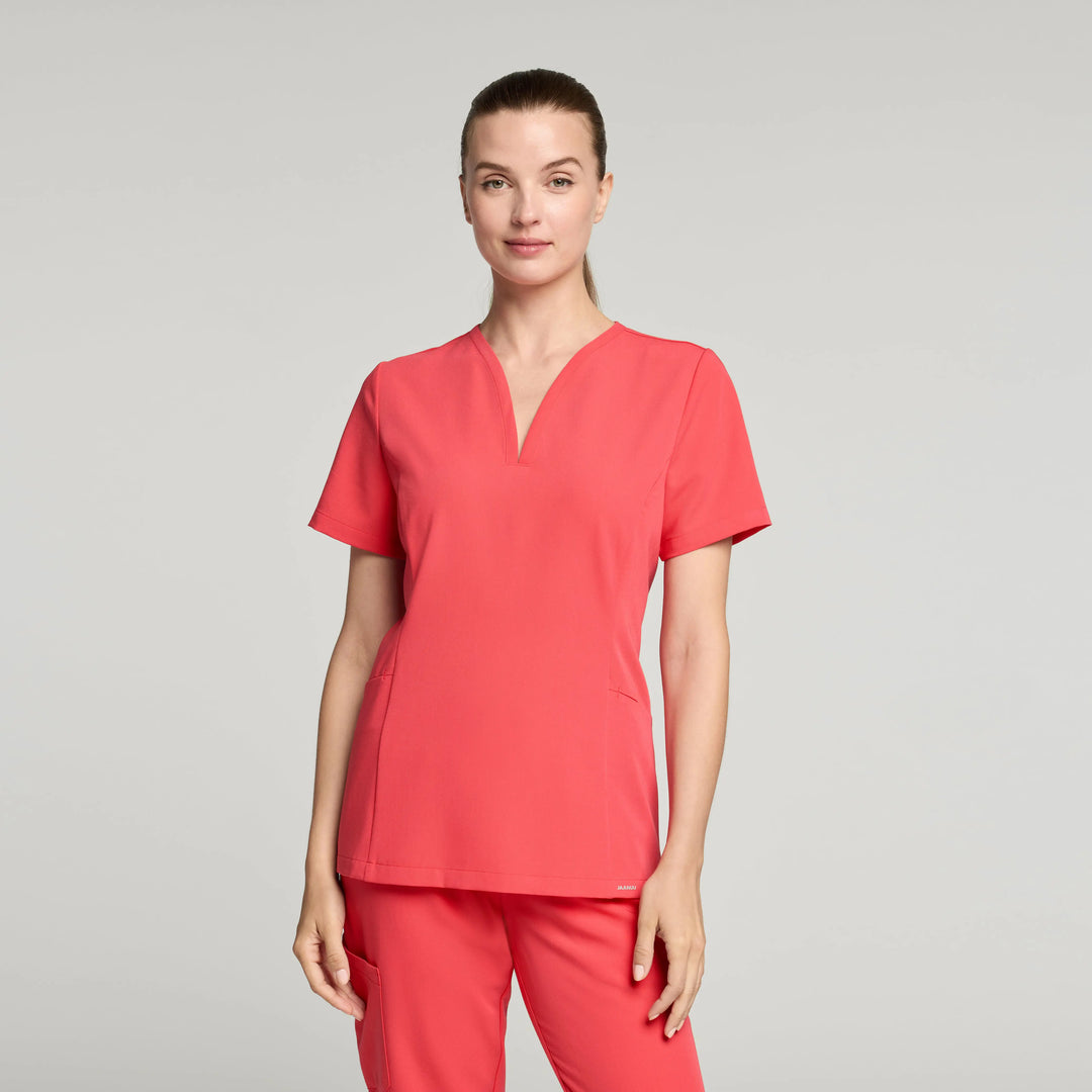 Jaanuu Scrubs Women's Calix Fit & Flare Scrub Top Coral | scrub-supply.com
