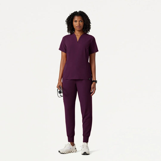 Jaanuu Scrubs Women's Calix Fit & Flare Scrub Top Deep Eggplant | scrub-supply.com