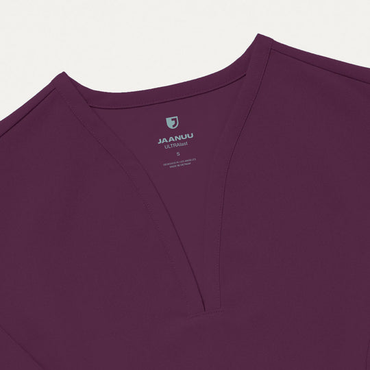 Jaanuu Scrubs Women's Calix Fit & Flare Scrub Top Deep Eggplant | scrub-supply.com