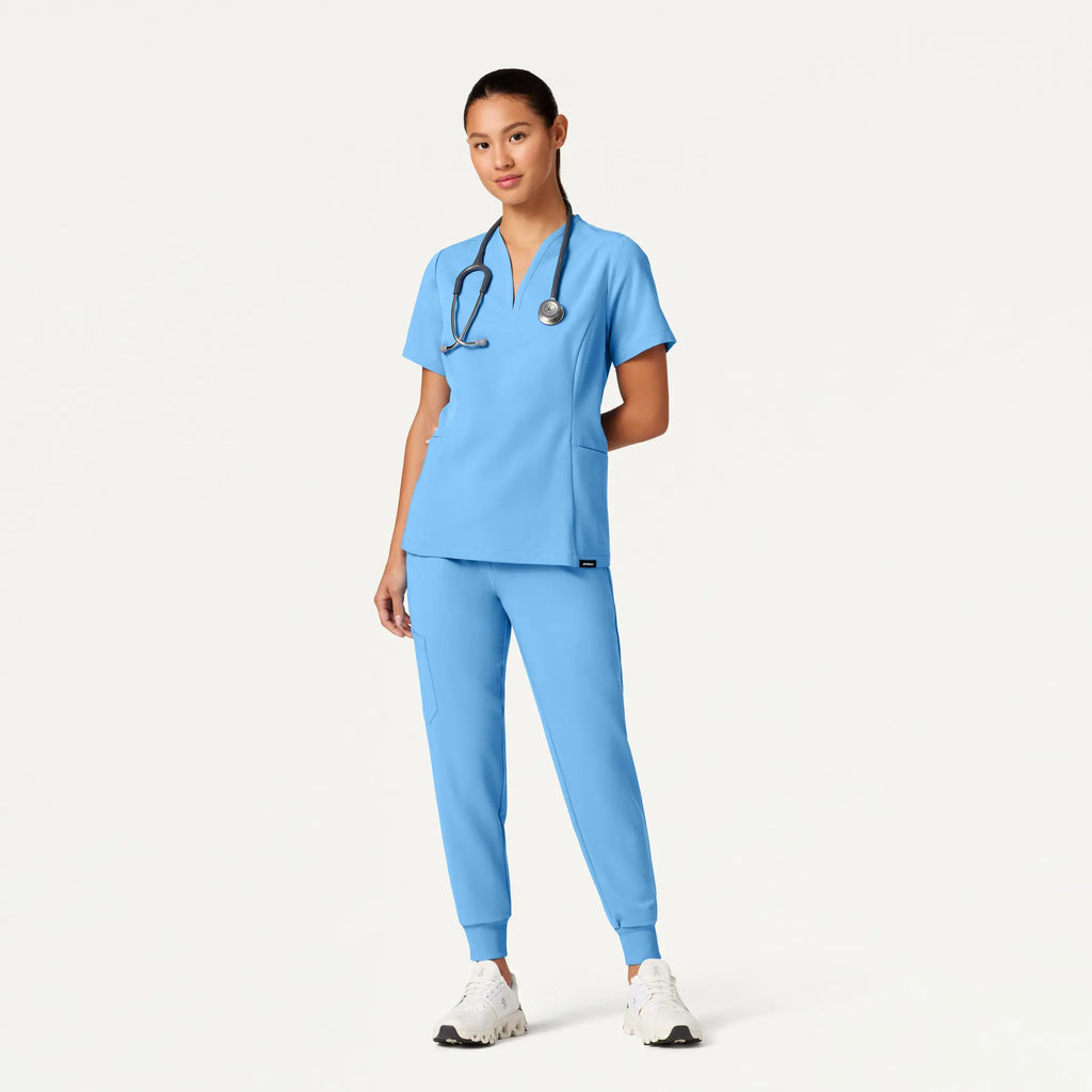 Jaanuu Scrubs Women's Calix Fit & Flare Scrub Top Sky Blue | scrub-supply.com