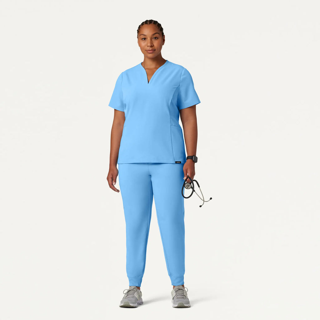 Jaanuu Scrubs Women's Calix Fit & Flare Scrub Top Sky Blue | scrub-supply.com