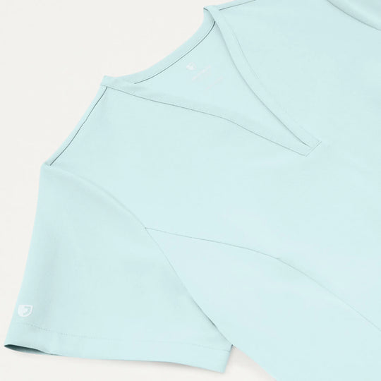 Jaanuu Scrubs Women's Calix Fit & Flare Scrub Top Sky Blue | scrub-supply.com