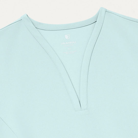 Jaanuu Scrubs Women's Calix Fit & Flare Scrub Top Sky Blue | scrub-supply.com