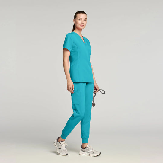 Jaanuu Scrubs Women's Calix Fit & Flare Scrub Top Marina | scrub-supply.com