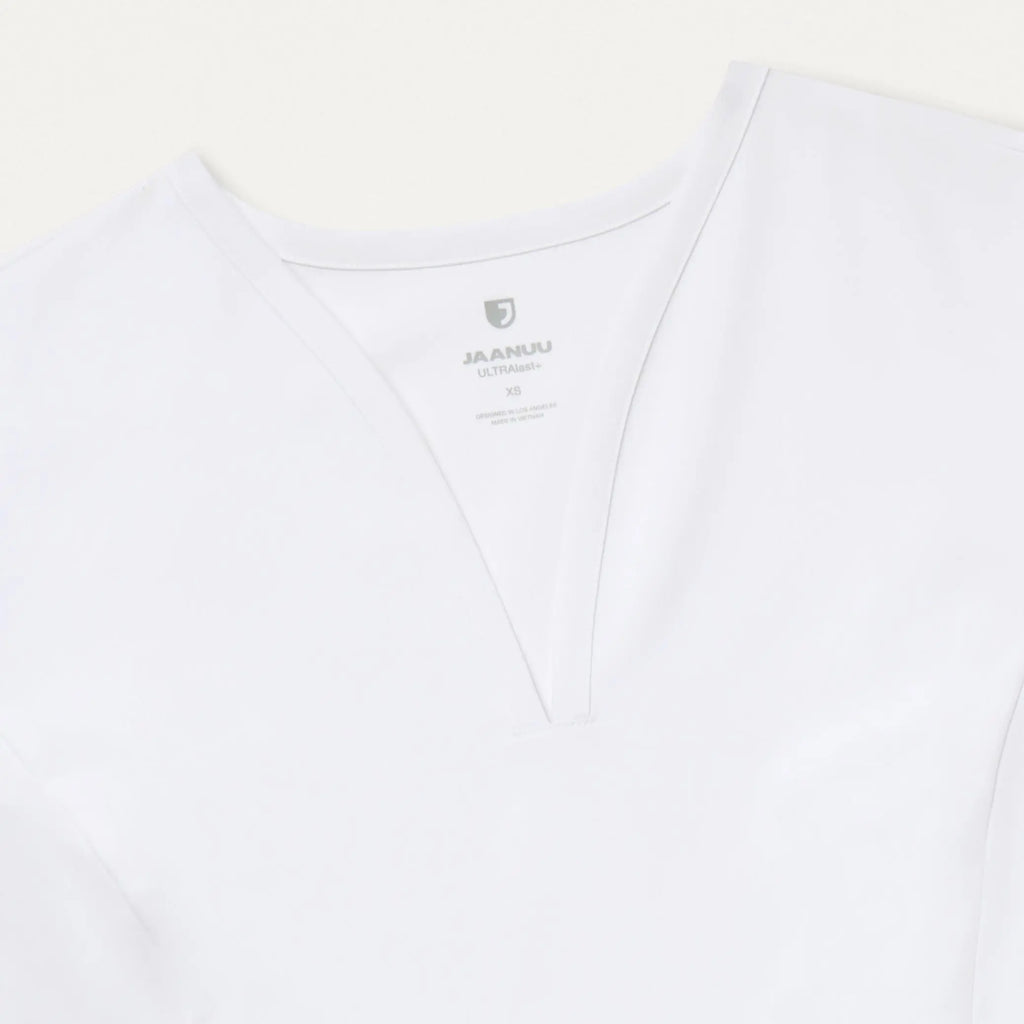 Jaanuu Scrubs Women's Calix Fit & Flare Scrub Top White | scrub-supply.com