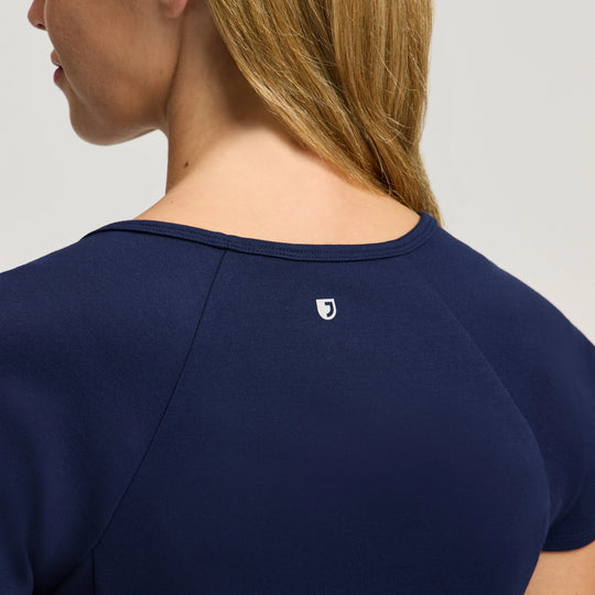 Jaanuu Scrubs Women's Sorrell Peplum Scrub Top Midnight Navy | scrub-supply.com